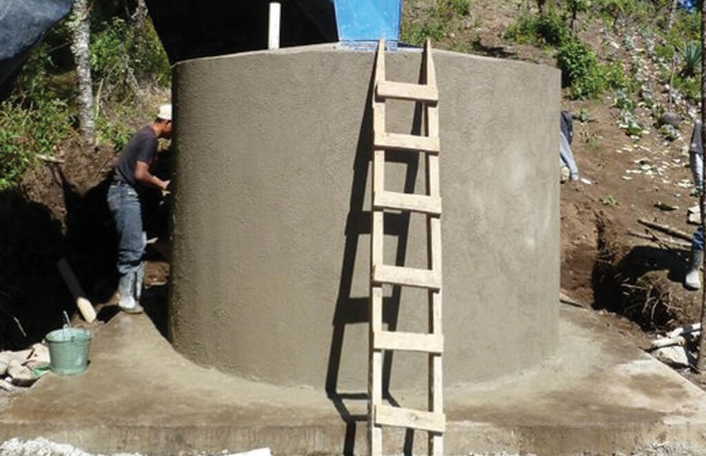 Workers in Guatemala work on water system tank